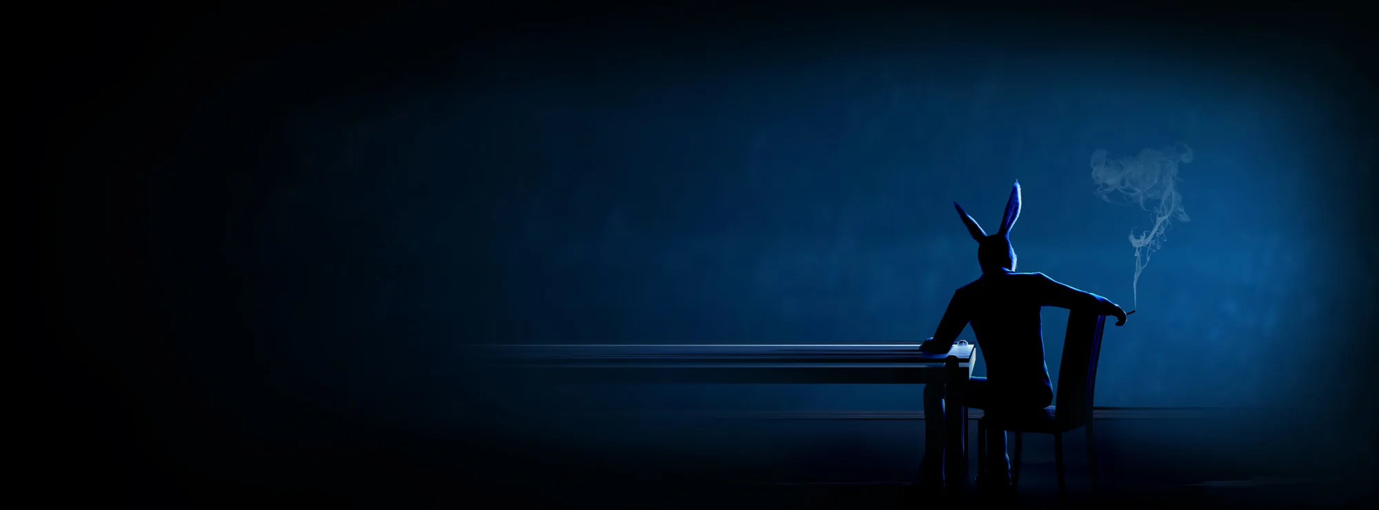 Ed seated at a table in a blue-lit room